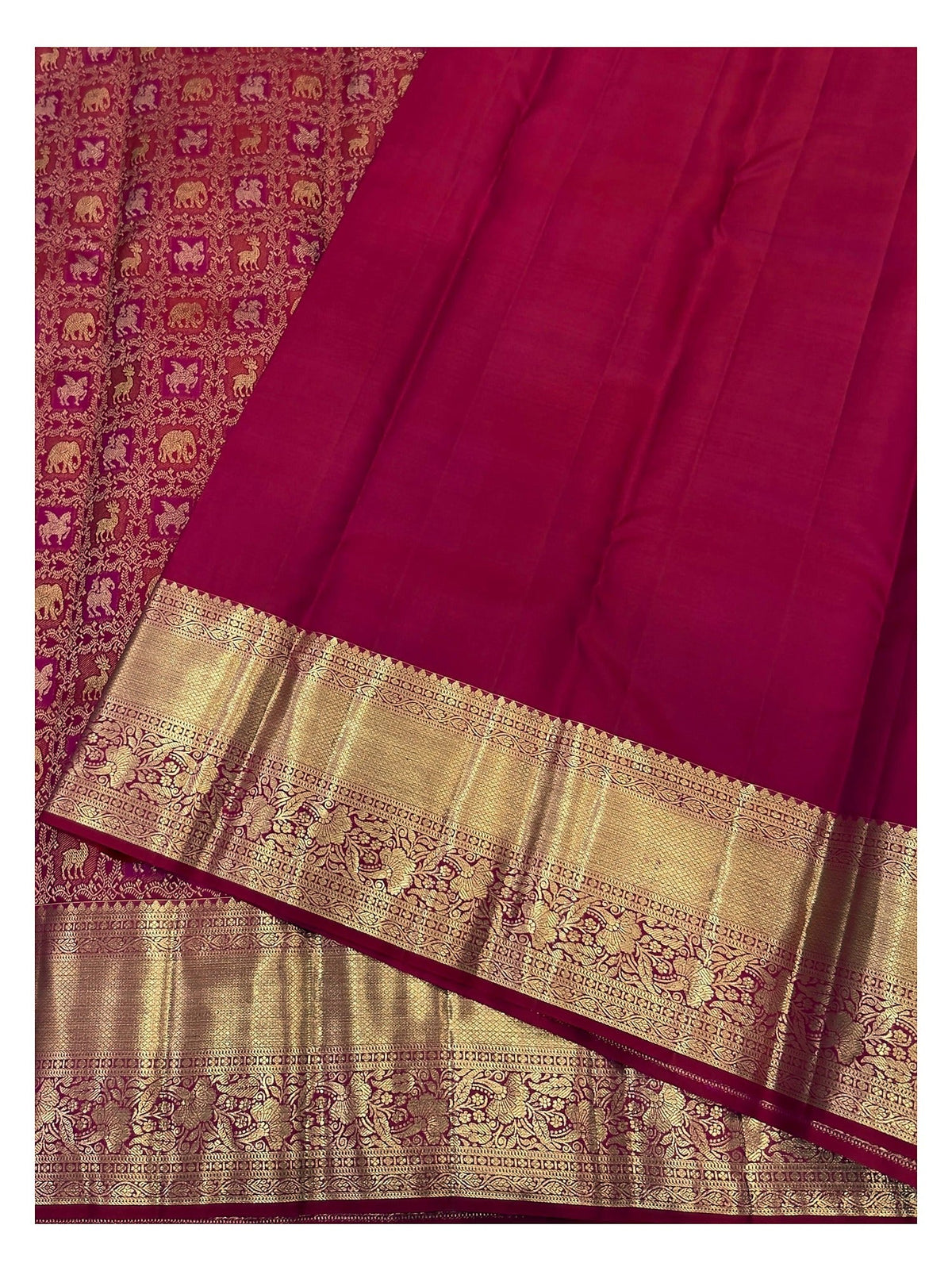 Matching magenta blouse piece and gold-toned border detail of handwoven Kanchipuram silk saree