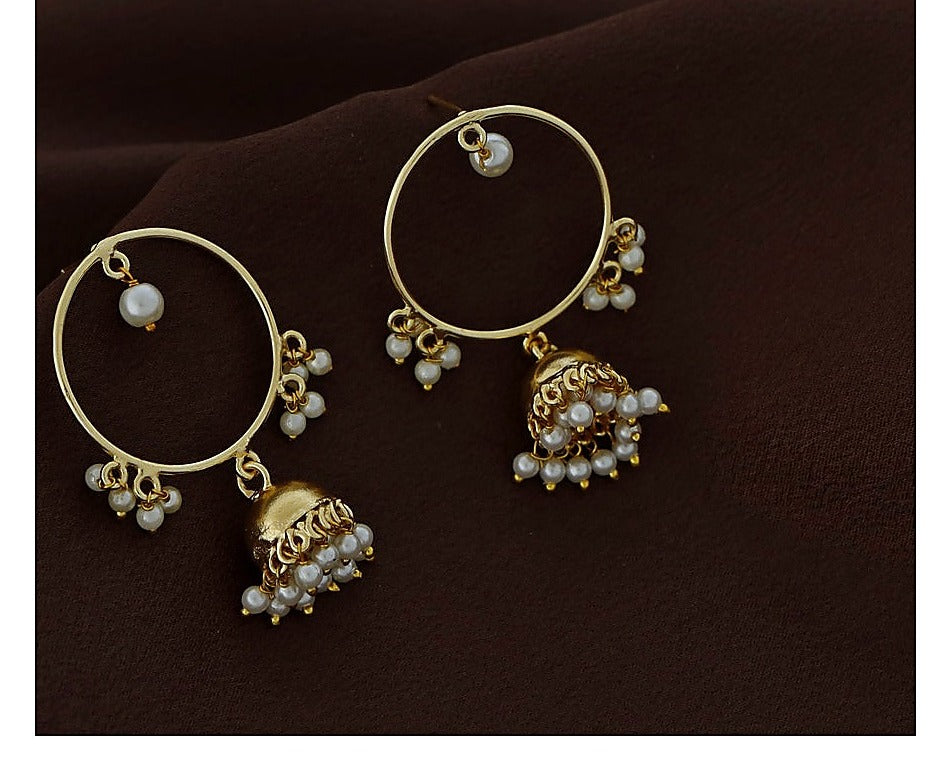 Close view of gold polish circle jhumka earrings with pearl bead detail