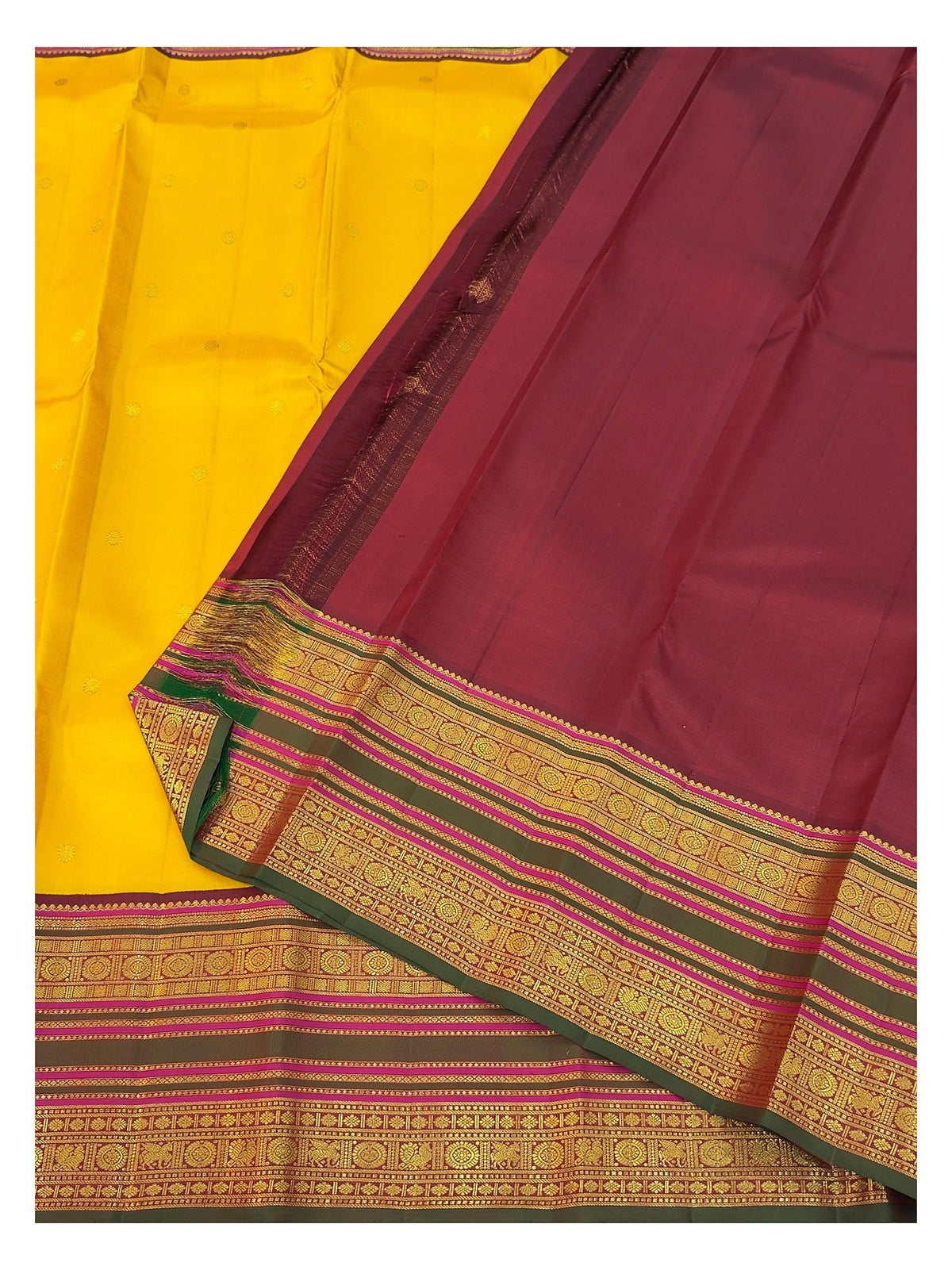 Contrast maroon blouse piece and border detail of the mustard yellow handwoven Kanchipuram silk saree