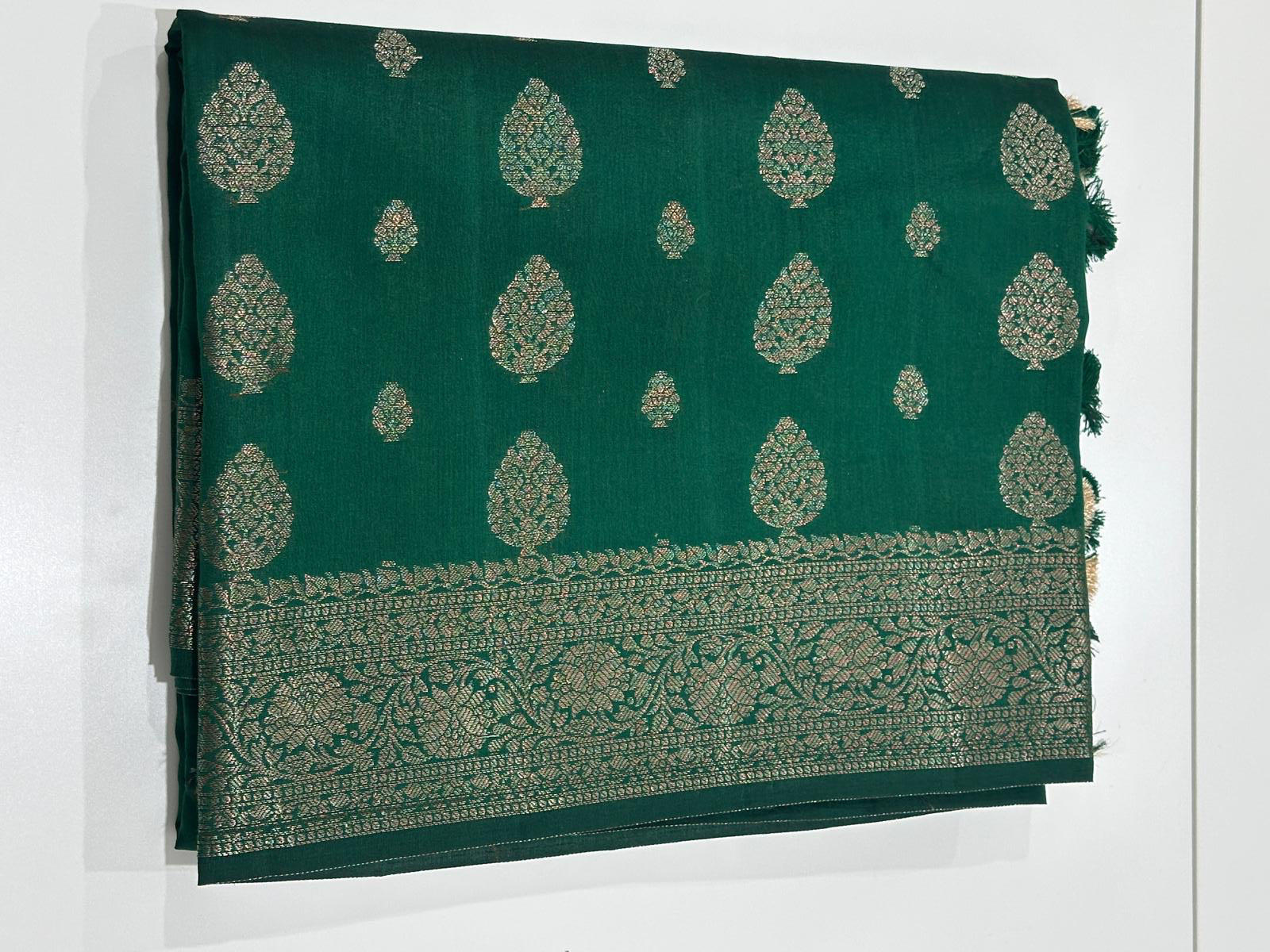 Fancy Chiniya silk saree in emerald green with gold zari butta motifs and woven border
