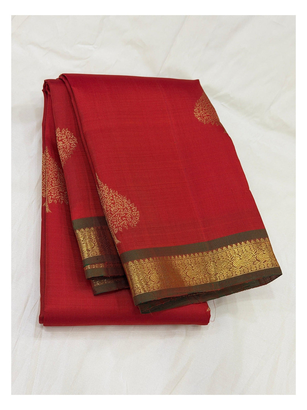 Deep red handwoven Kanchipuram silk saree with gold buttas and contrast olive-brown woven border