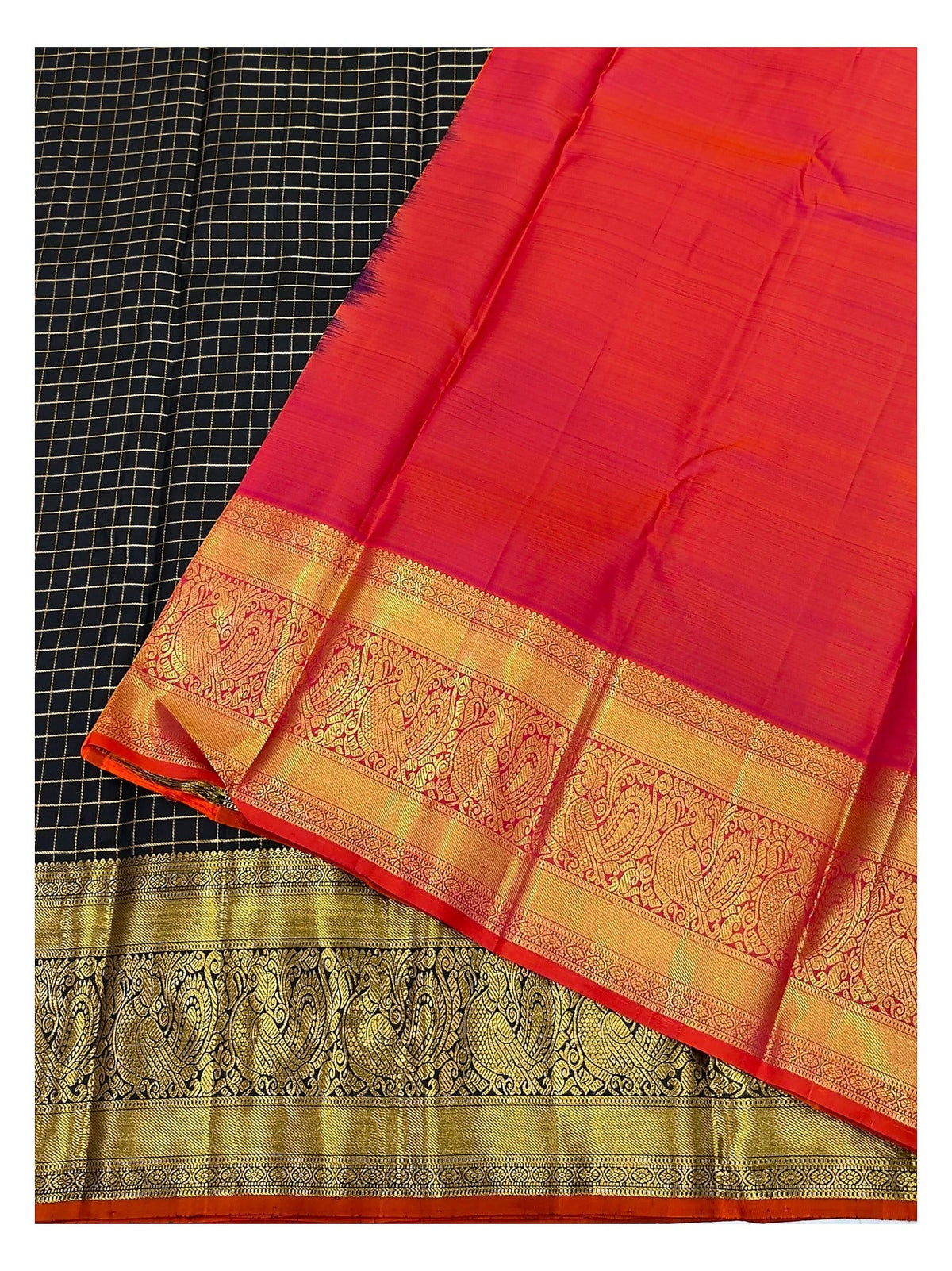 Close view of the saree showing black checked body and vibrant vermilion-red contrast pallu with woven border
