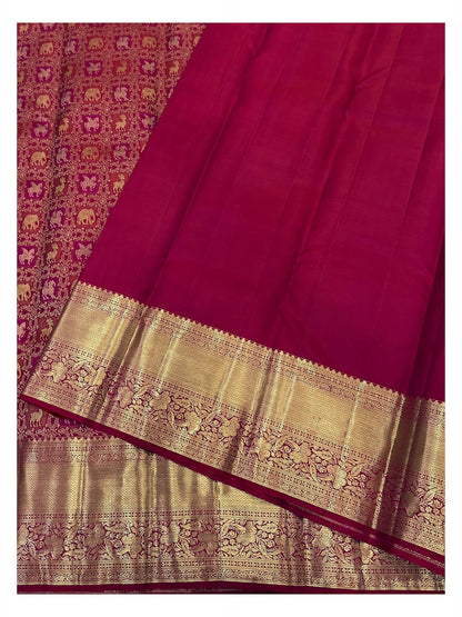Matching magenta blouse piece and gold-toned border detail of handwoven Kanchipuram silk saree