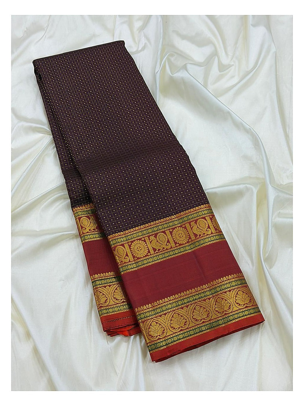 Full folded view of the deep plum handwoven Kanchipuram silk saree with maroon contrast border and gold-toned woven detailing