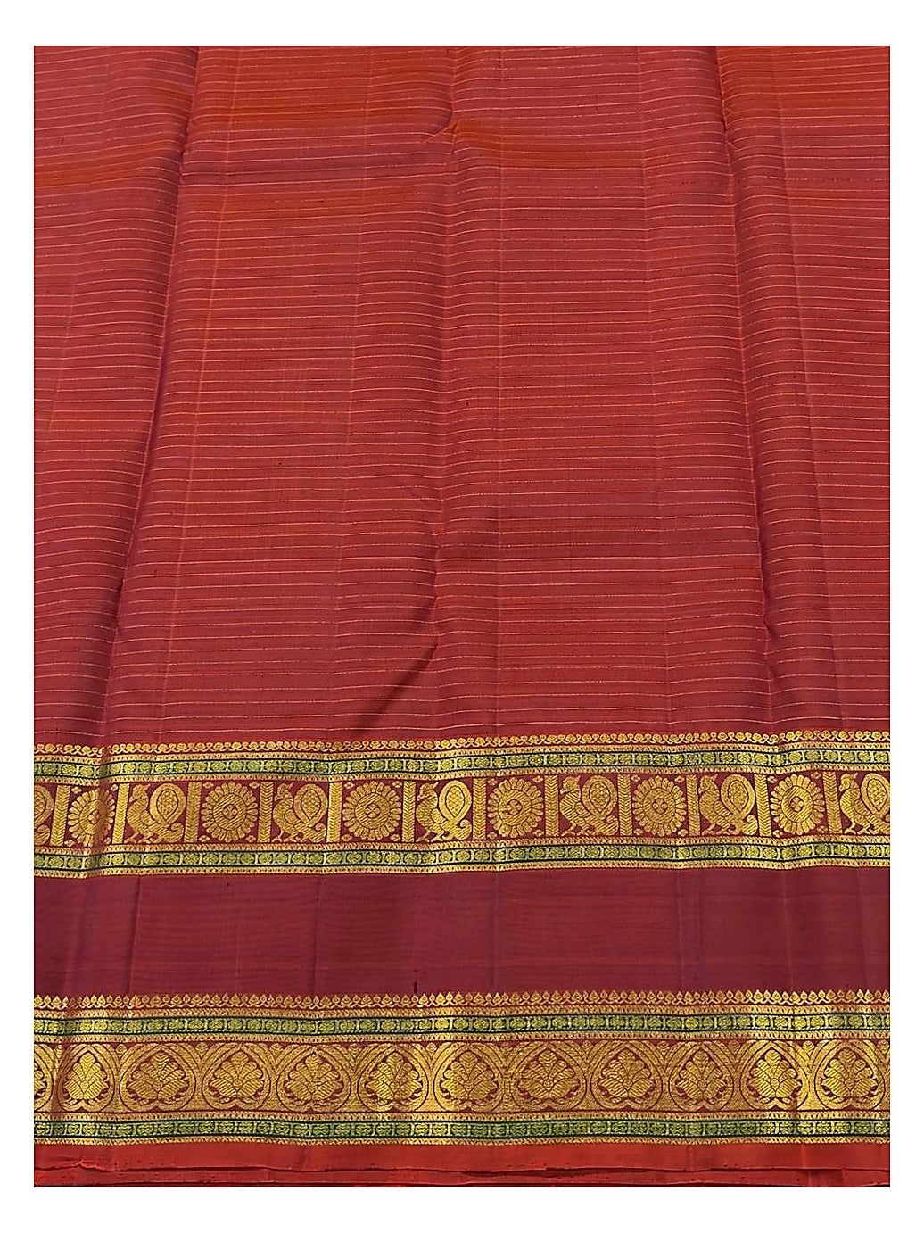 Close-up of the maroon border with gold-toned woven motifs and fine stripe texture on the saree body