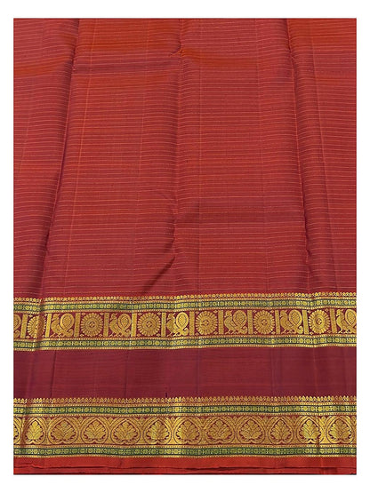 Close-up of the maroon border with gold-toned woven motifs and fine stripe texture on the saree body