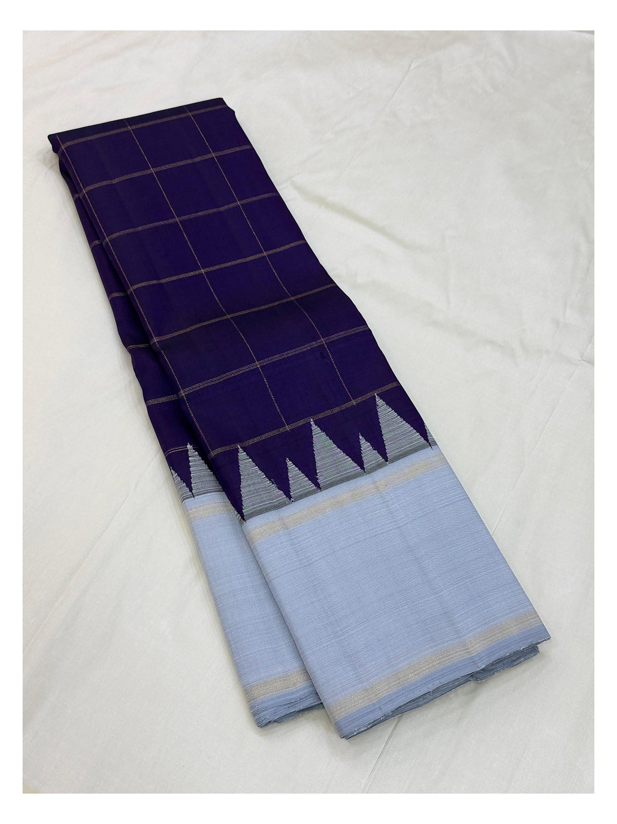 Folded view of the deep purple and ice blue handwoven Kanchipuram silk saree
