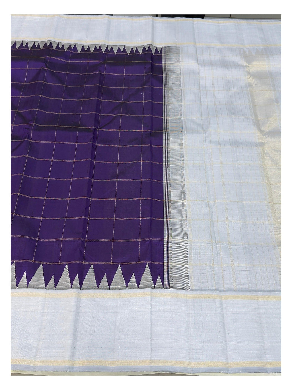 Open view showing the checked purple body and ice blue pallu of the handwoven Kanchipuram silk saree
