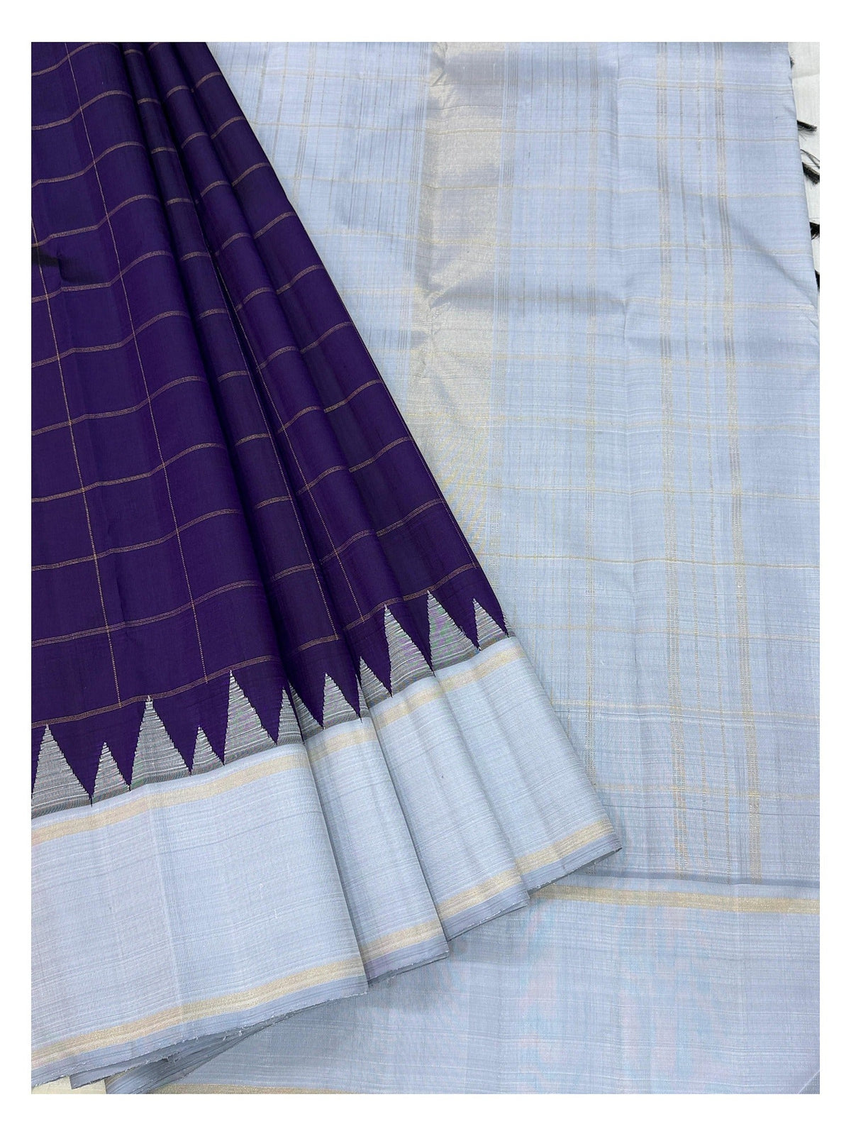 Draped detail of the deep purple checked body and ice blue border of the handwoven Kanchipuram silk saree