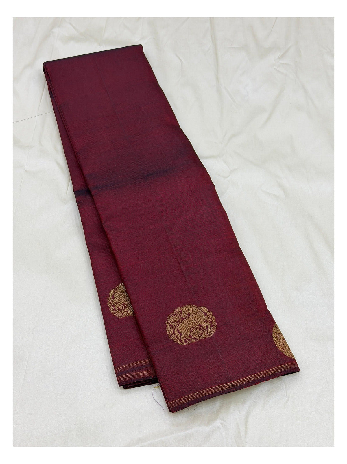 Folded view of deep wine handwoven Kanchipuram silk saree with pure zari detailing