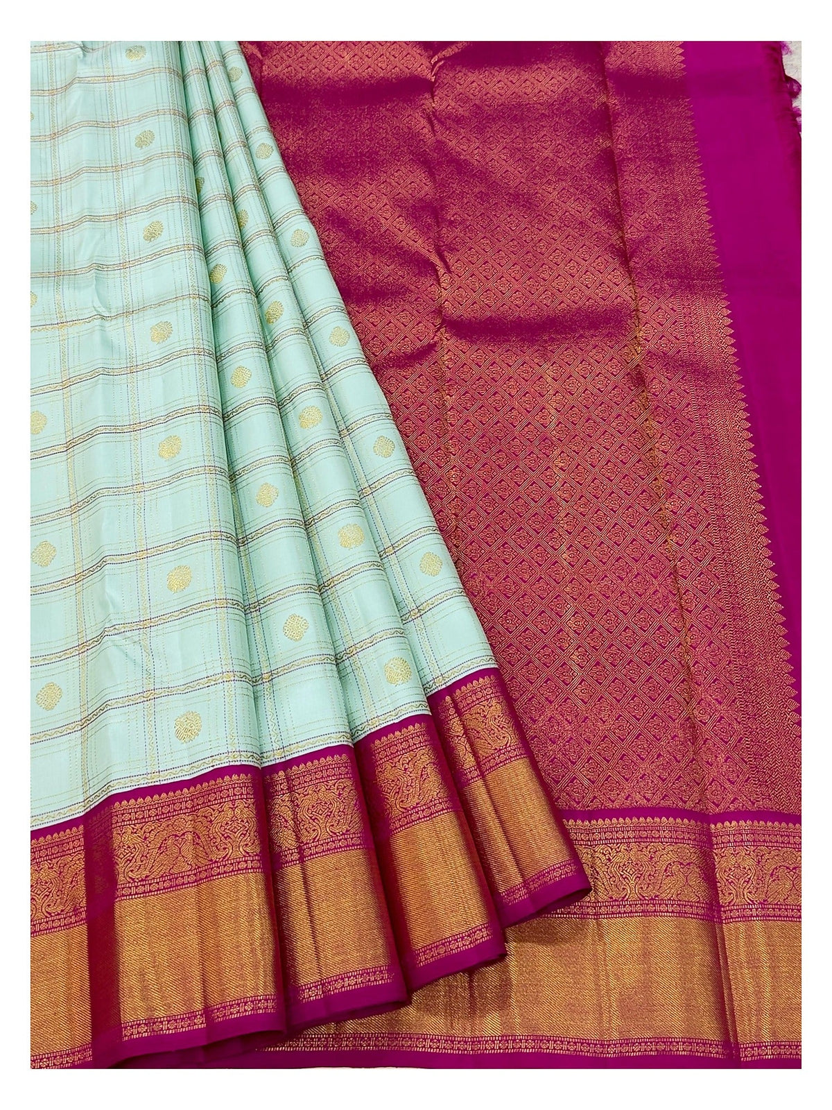 Draped view showing ice blue checked body and magenta patterned pallu of handwoven Kanchipuram silk saree