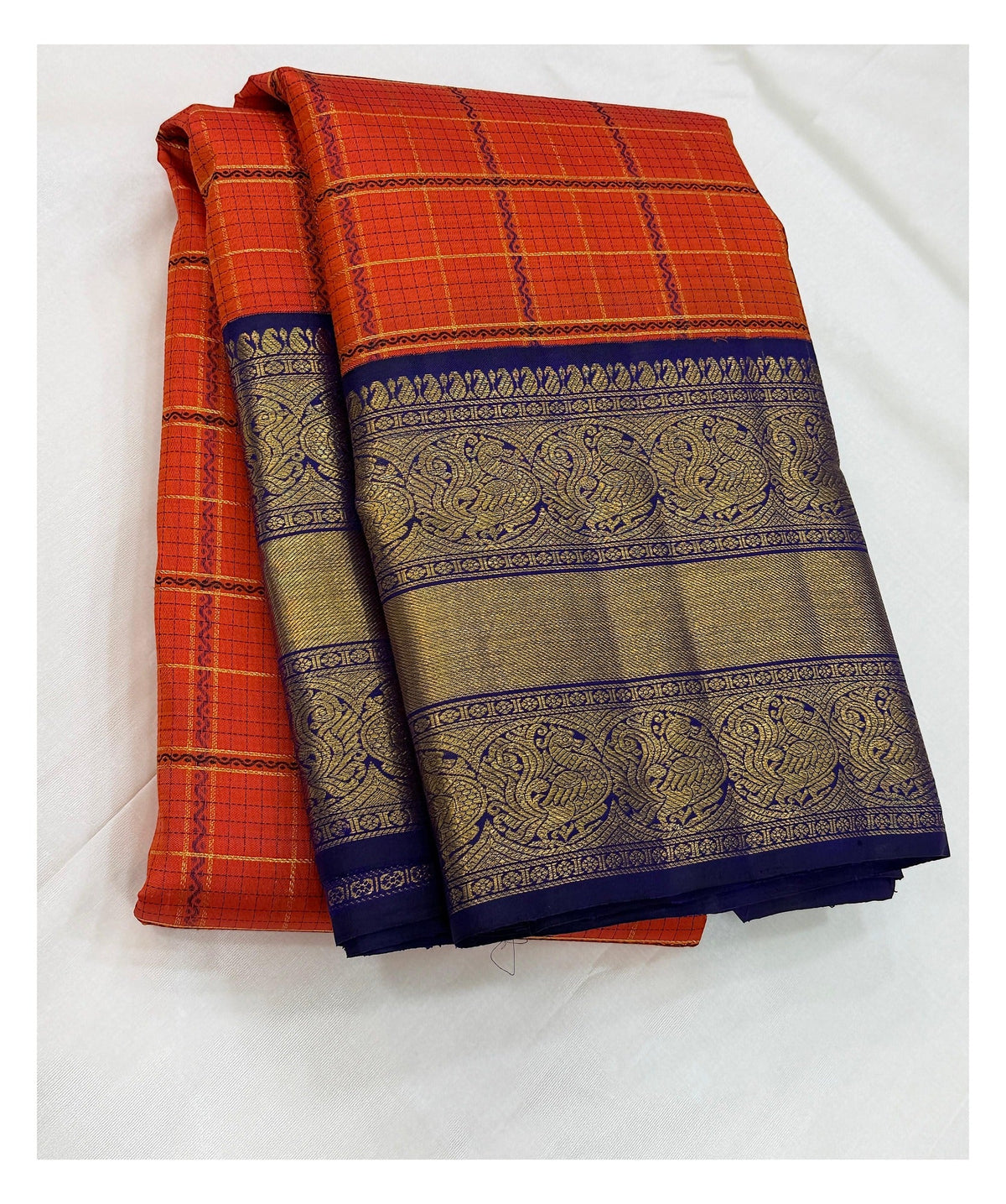 Handwoven Kanchipuram Silk Saree in Orange Checks with Royal Blue Peacock Border front view