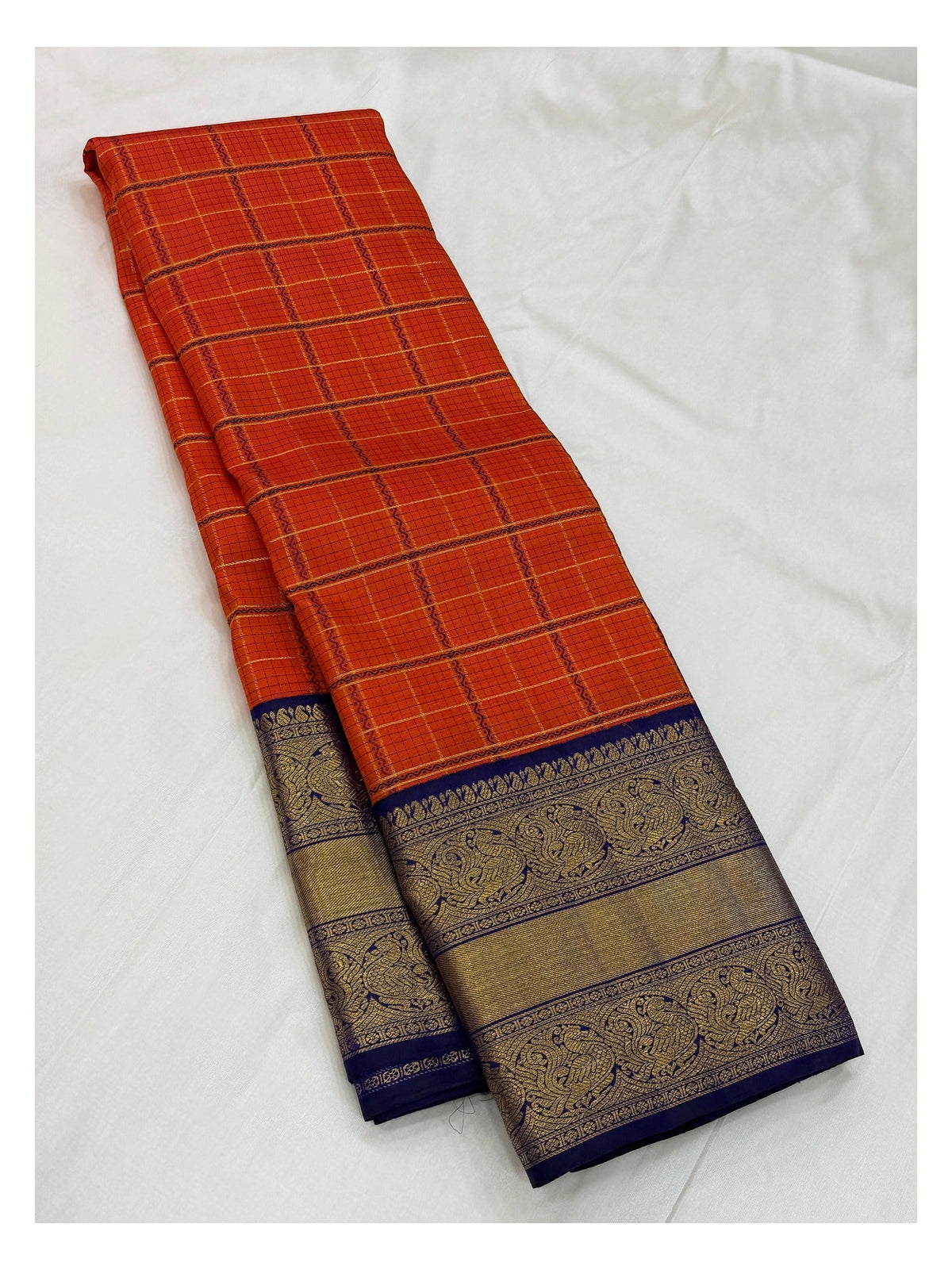 Handwoven Kanchipuram Silk Saree in Orange Checks with Royal Blue Peacock Border