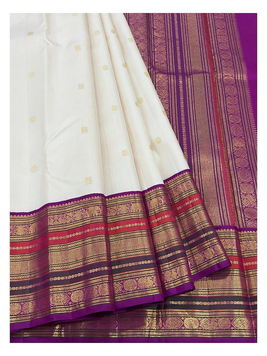 Detailed view of the ivory saree border and magenta pallu with gold-toned woven motifs
