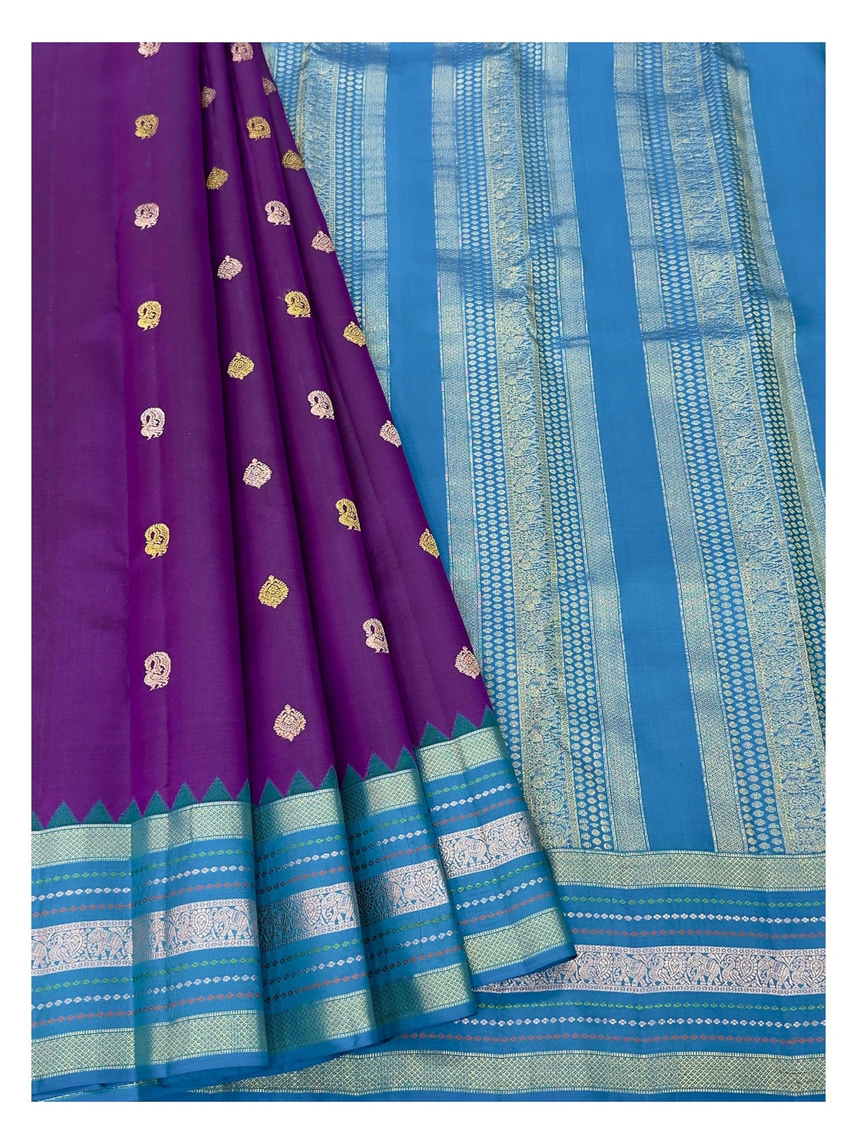 Draped view of purple Kanchipuram silk saree with teal blue zari-style pallu