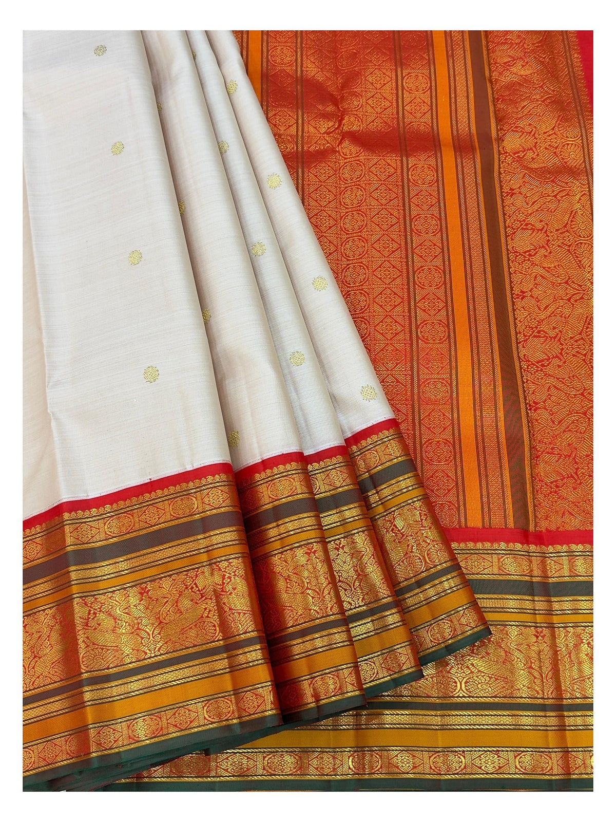 Pleated view of the saree showing blush pink body, ornate red pallu, and broad gold-toned border