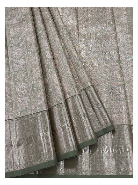 Detailed view of handwoven Kanchipuram silk saree showing motif panels and antique gold woven border