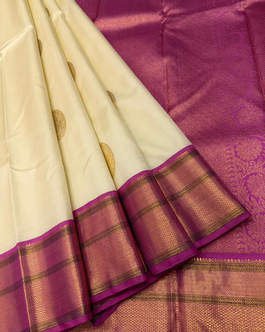 Handwoven ivory and magenta silk saree with rich gold zari work
