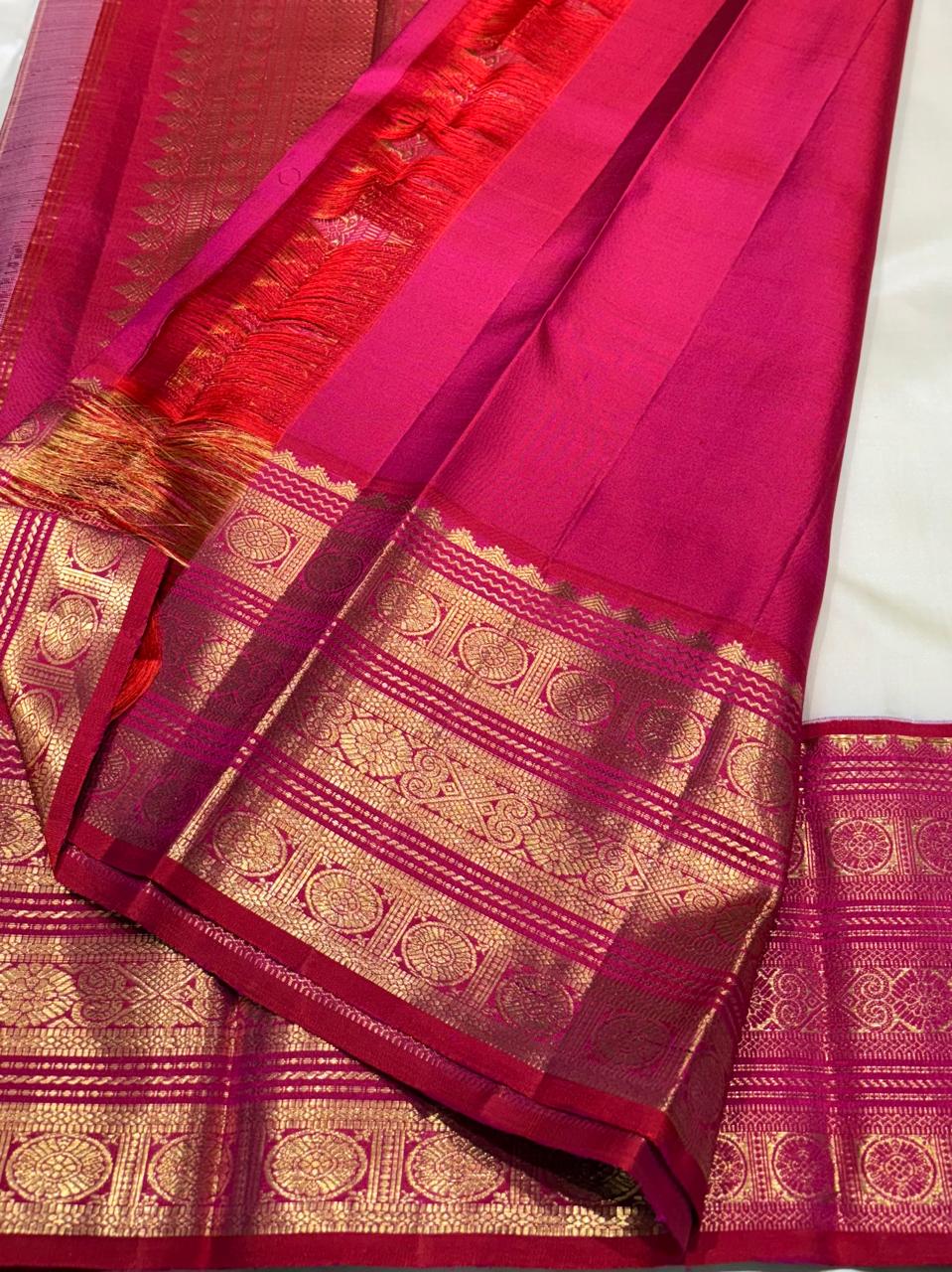 Pure silk ivory saree with golden motifs and red-pink pallu – close-up