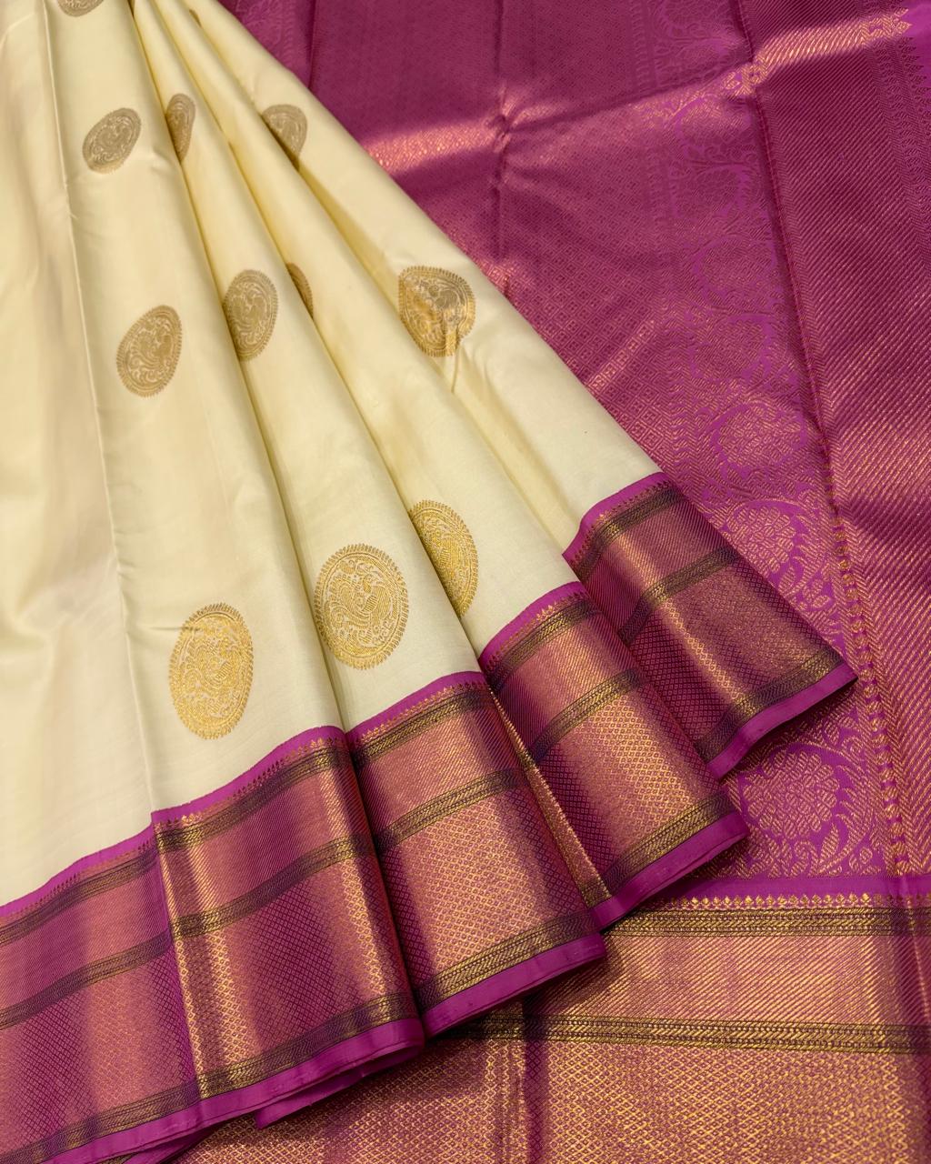Ivory Kanchipuram silk saree with magenta border and gold zari buttas – full view