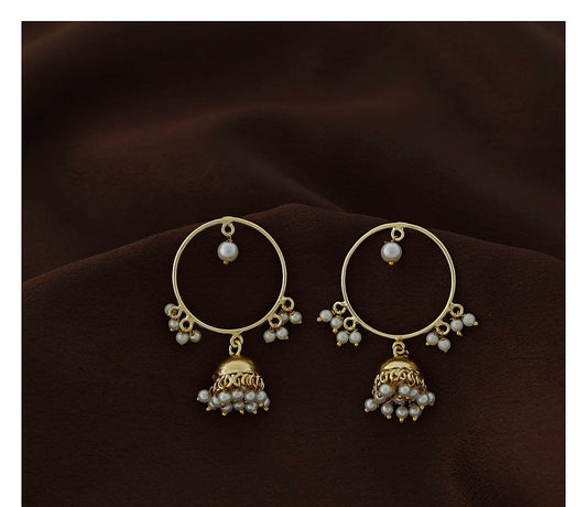 Gold polish circle jhumka earrings with pearl bead detail on dark brown fabric