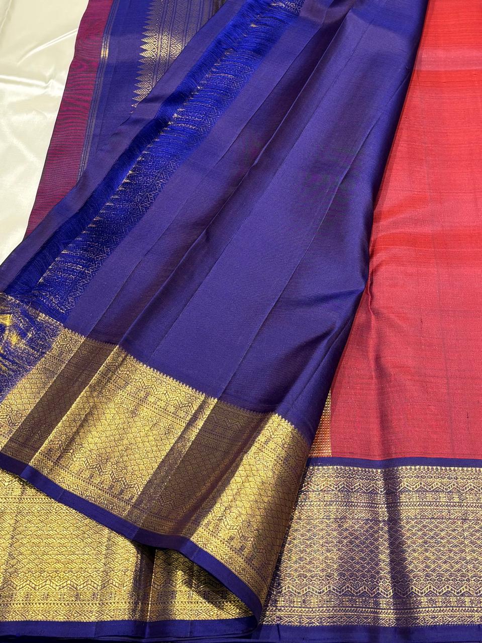 Elegant red silk saree with contrasting blue border for weddings