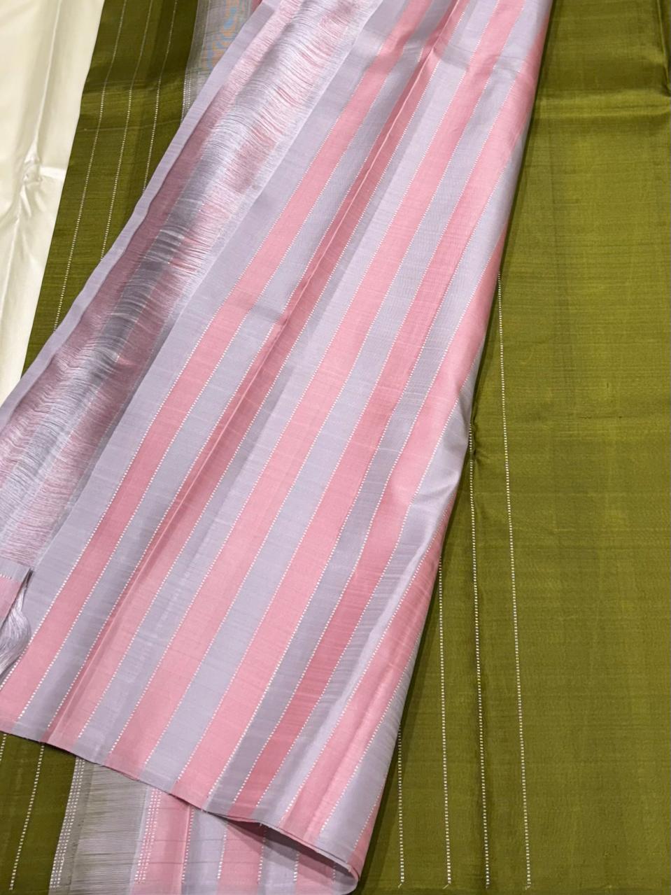 Handwoven pure silk saree with green body and striped contrast pallu – close-up