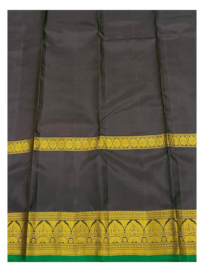 Close view of deep plum pallu with gold-toned woven border detail and green selvedge