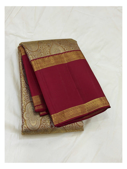 Maroon handwoven Kanchipuram silk saree folded with antique gold woven body and contrast zari border