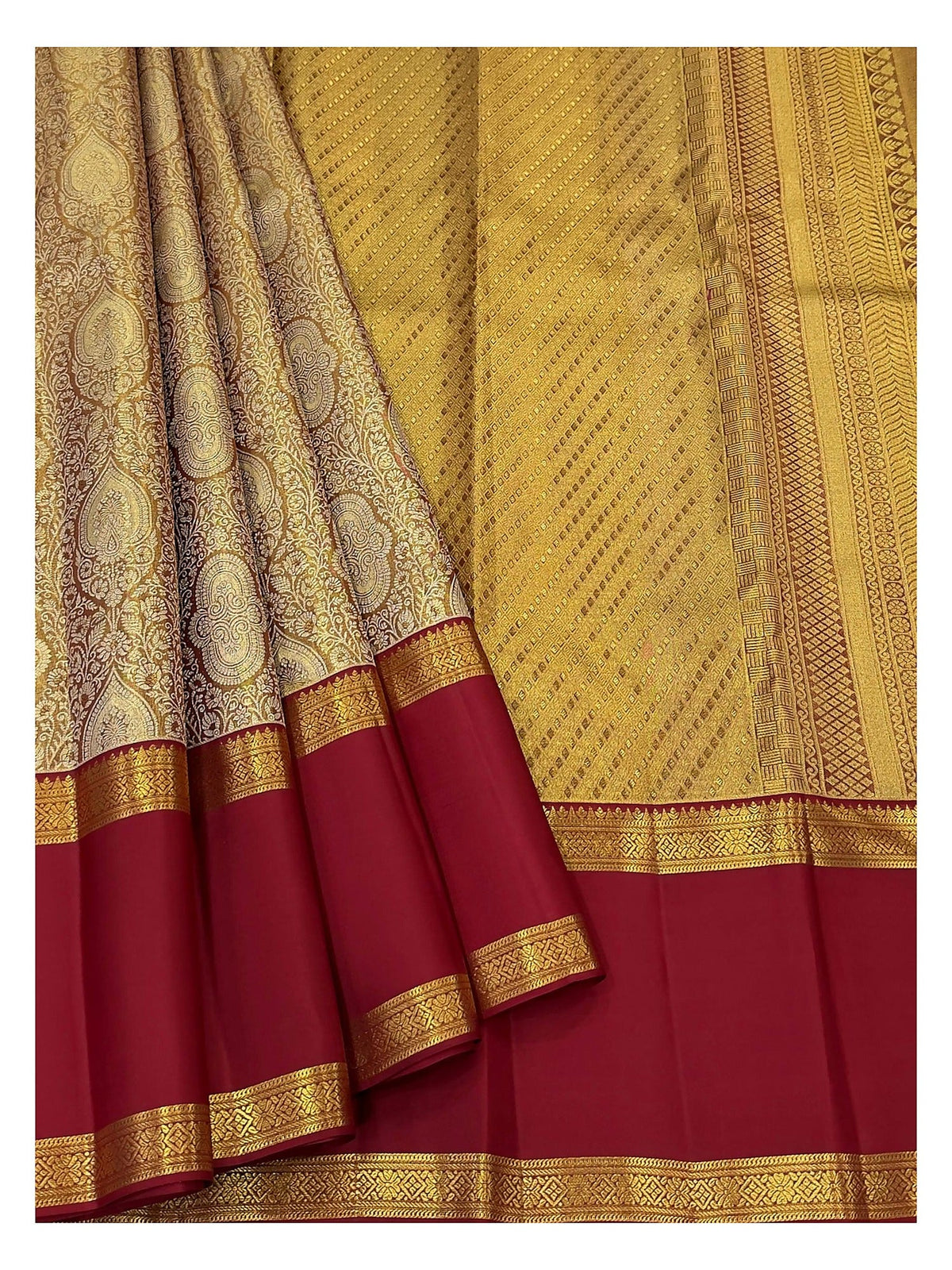 Detailed view of antique gold woven body and maroon contrast border on silk saree