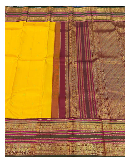Handwoven Kanchipuram silk saree spread open to show mustard body, broad border and richly woven pallu