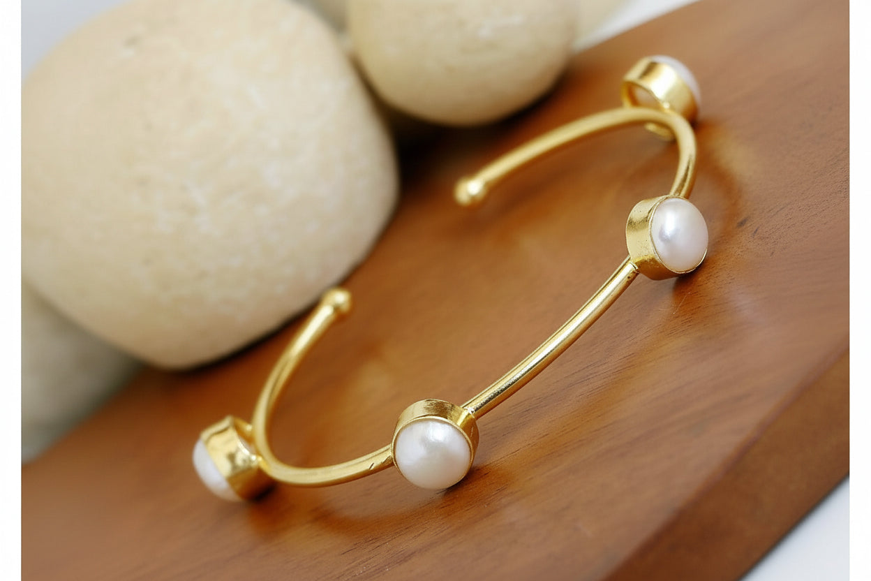 Pearl Station Bracelet - Gold Tone Open Cuff with Four Pearl Details front view