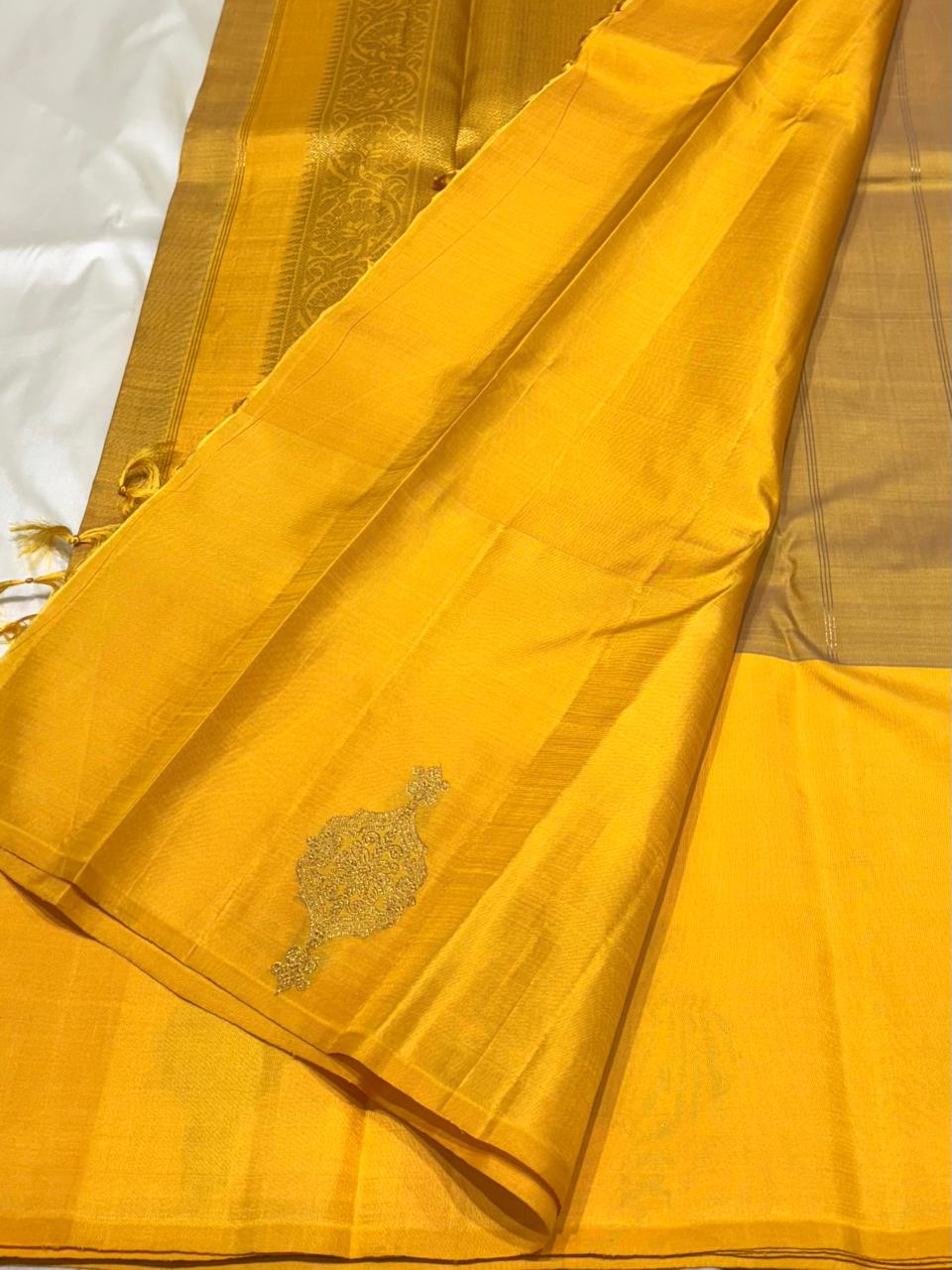 Handwoven pure silk saree with mustard yellow body and intricate zari motifs – close-up