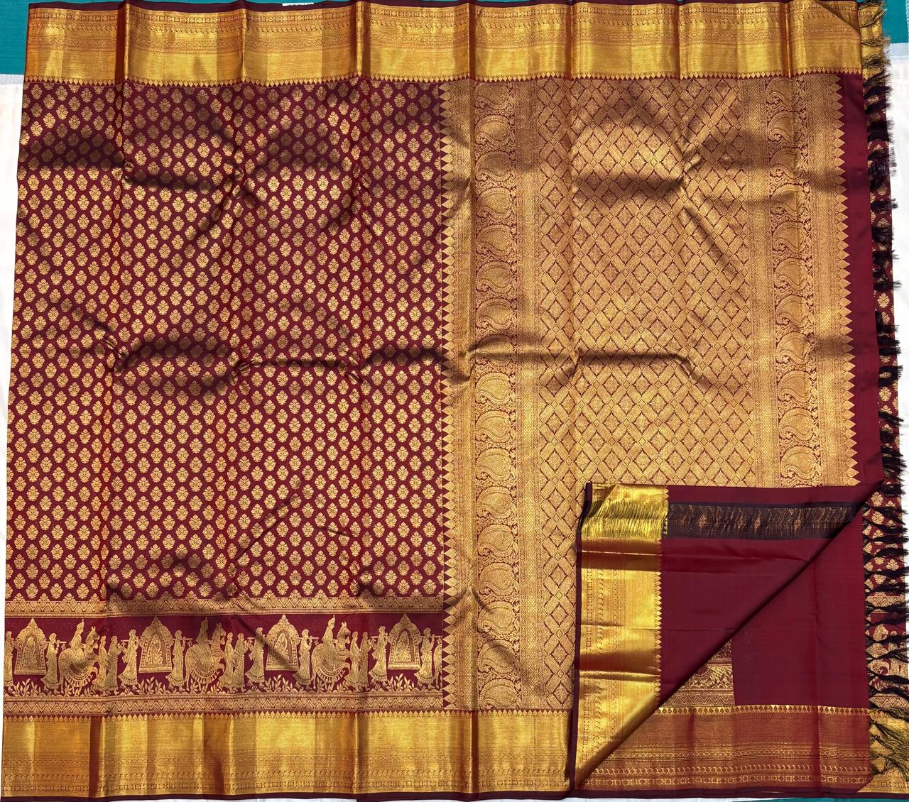 Elegant maroon silk saree with zari craftsmanship and cultural motifs
