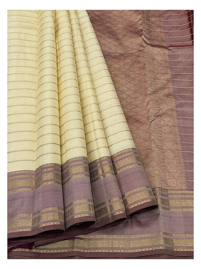 Pure silk saree drape showing cream body, mauve border, and woven pallu