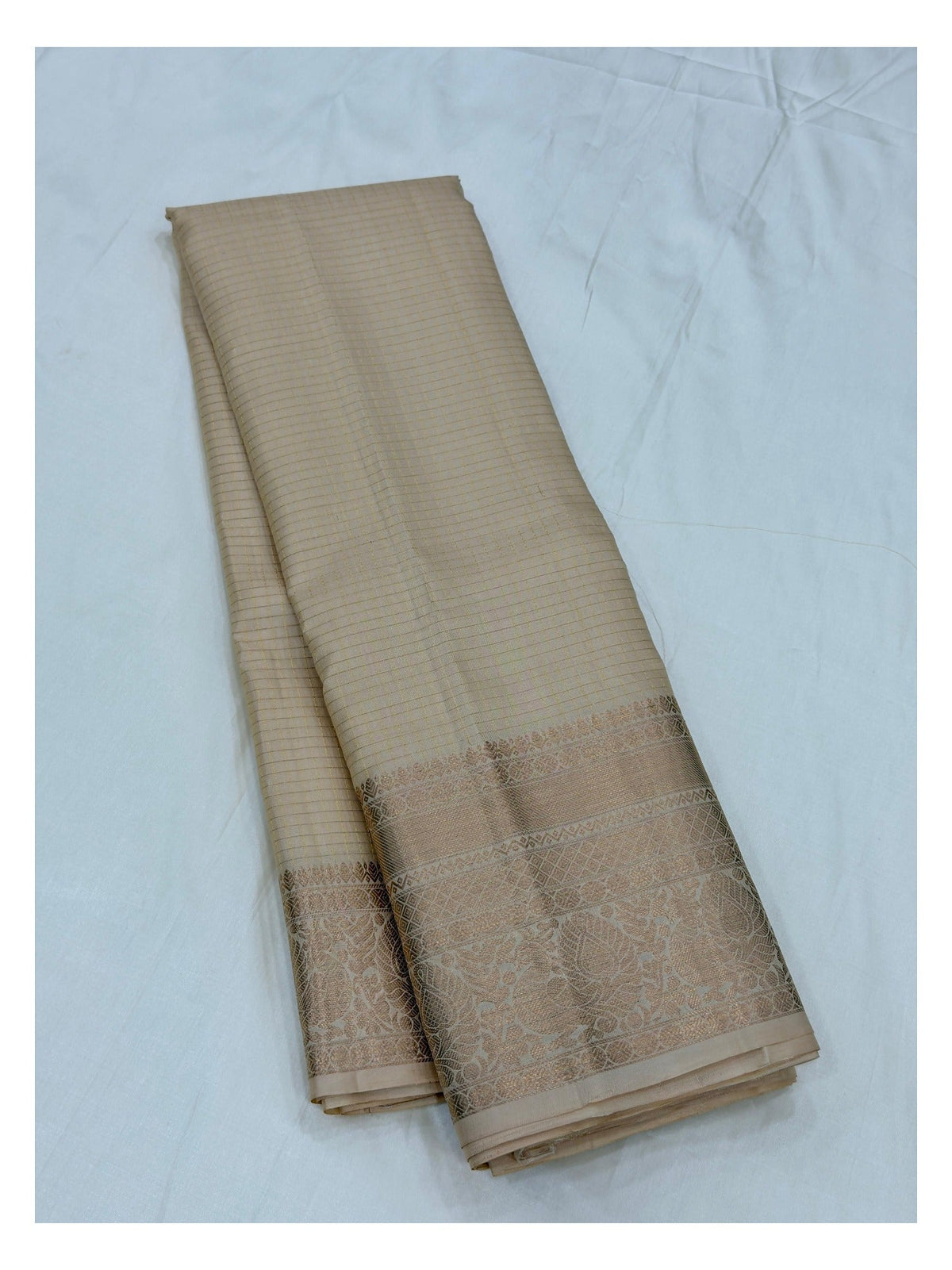 Soft gold beige pure silk saree showing the body and woven zari border