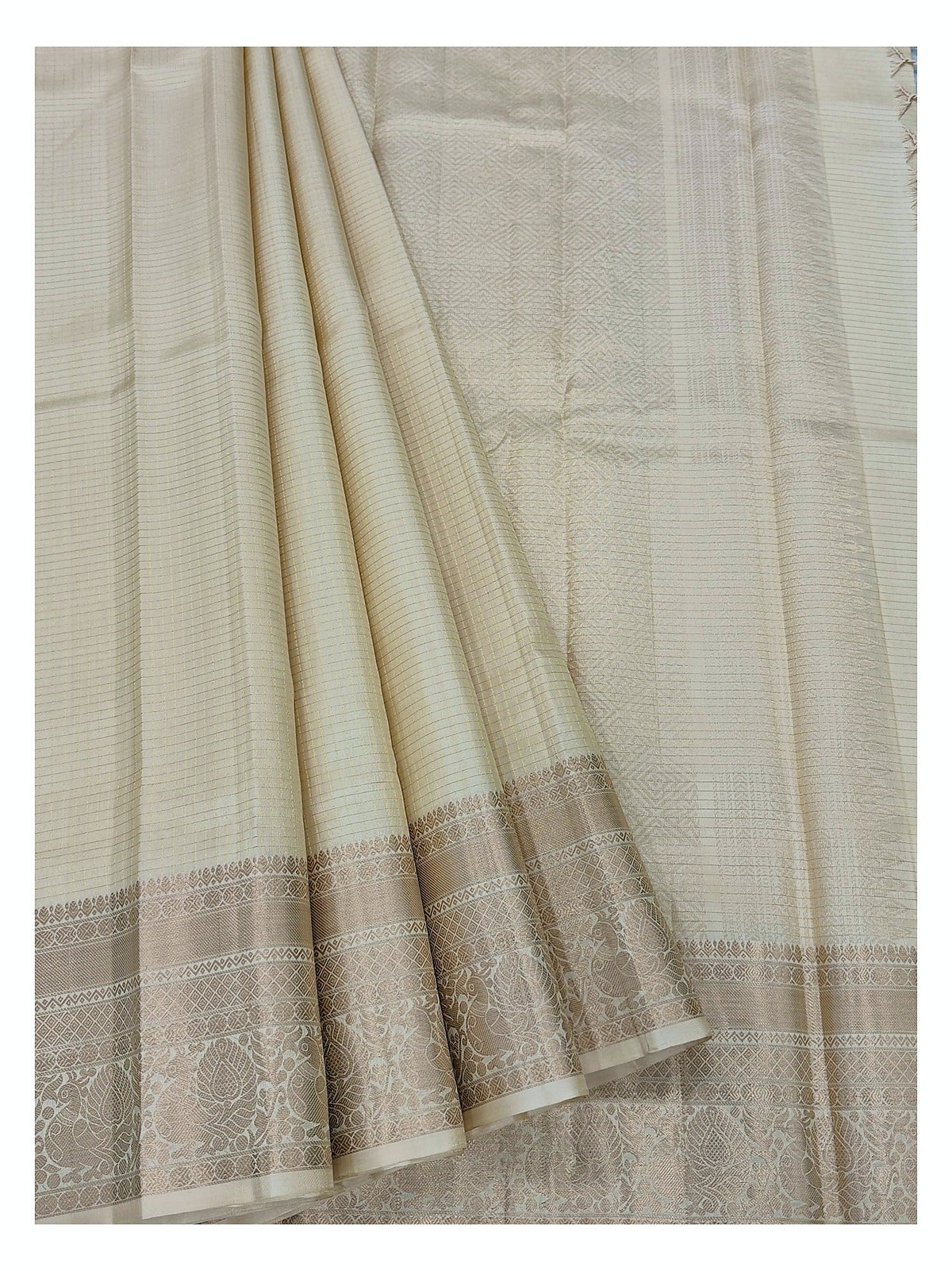 Draped view of the soft gold beige pure silk saree with zari detailing