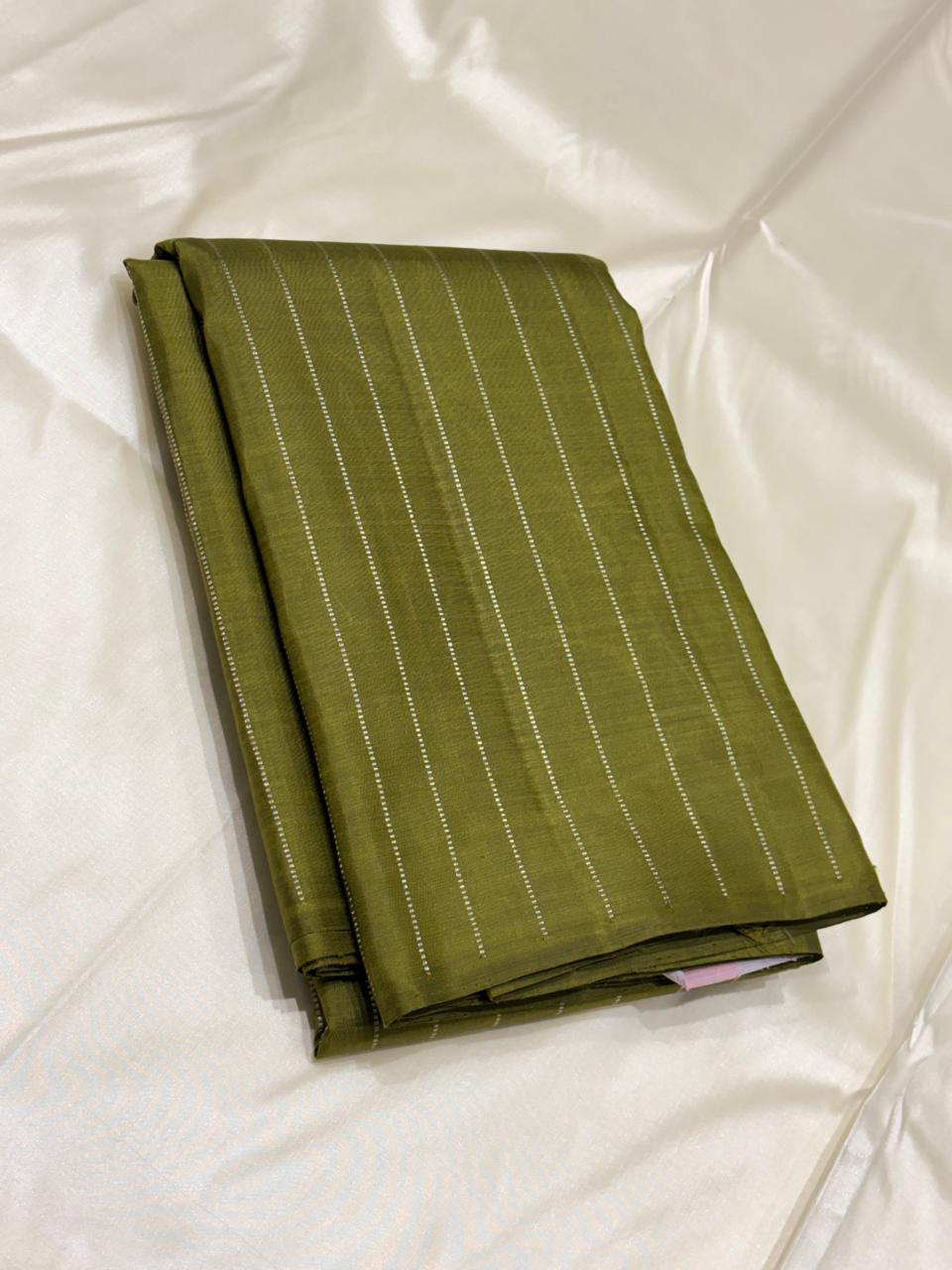 Modern Kanchipuram silk saree with green body and pink striped pallu