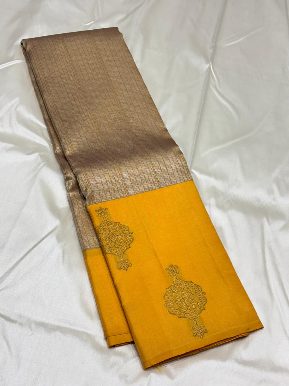 Kanchipuram silk saree in mustard with contrasting silver blouse piece