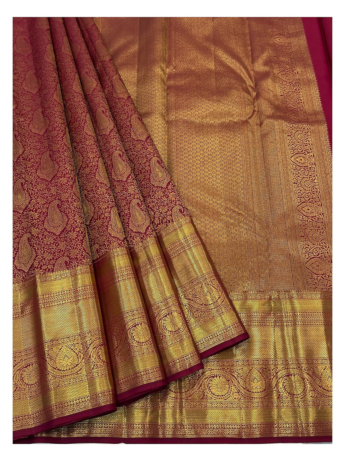 Wine handwoven Kanchipuram silk saree showing rich gold woven pallu and paisley motifs