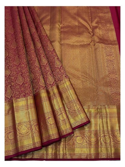 Wine handwoven Kanchipuram silk saree showing rich gold woven pallu and paisley motifs